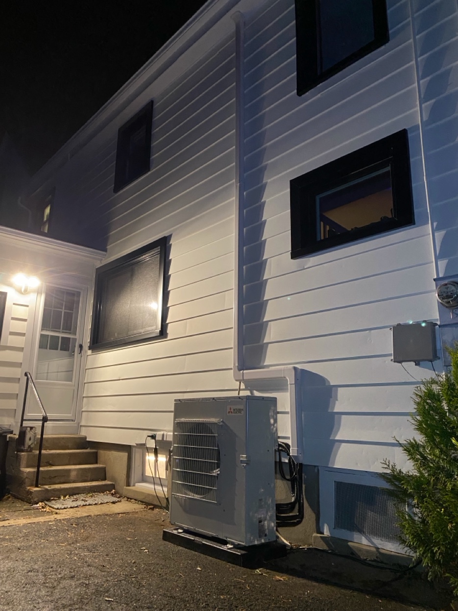 Mitsubishi heat pump outdoor unit installed by Airmax Heating \& A/C